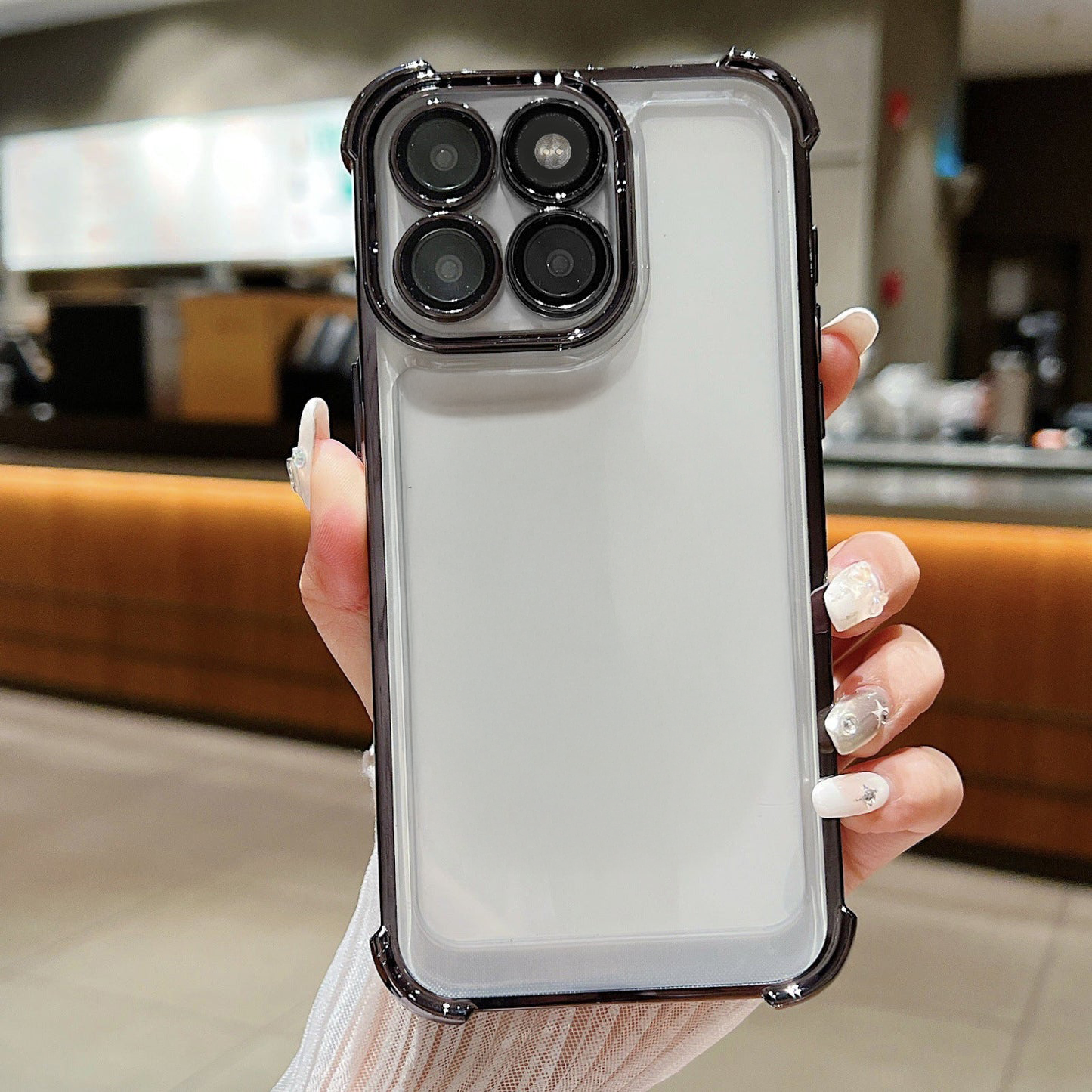 Person holding a phone with a Motorola Edge 60 Pro 5G clear case in an indoor setting